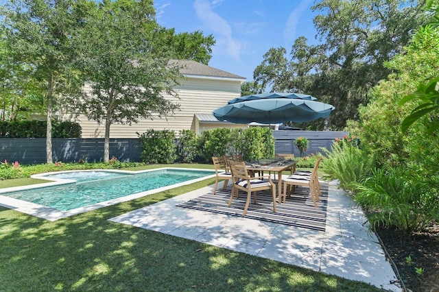 view of pool with a patio, outdoor dining area, fence, and a fenced in pool