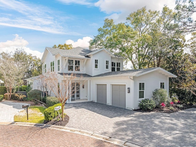 156 Beacon Point Dr, Santa Rosa Beach, FL 32459 - modern inspired farmhouse with decorative driveway, an attached garage, roof with shingles, and french doors