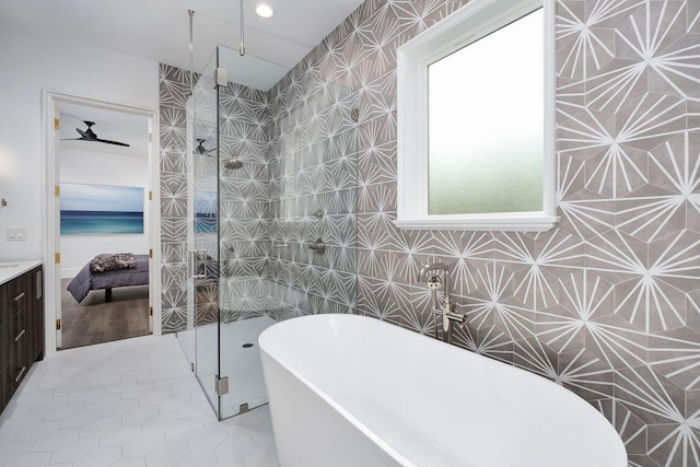 156 Beacon Point Dr, Santa Rosa Beach, FL 32459 - full bathroom with walk in shower, a freestanding tub, tile walls, tile patterned floors, and vanity