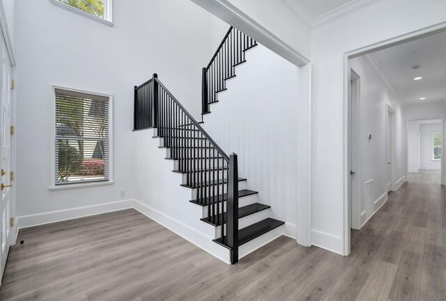 156 Beacon Point Dr, Santa Rosa Beach, FL 32459 - stairs featuring ornamental molding, wood finished floors, baseboards, and recessed lighting