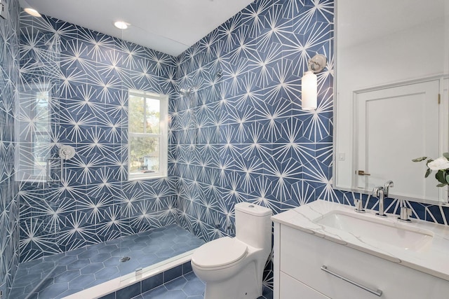 156 Beacon Point Dr, Santa Rosa Beach, FL 32459 - full bathroom featuring a tile shower, toilet, vanity, tile patterned floors, and vaulted ceiling