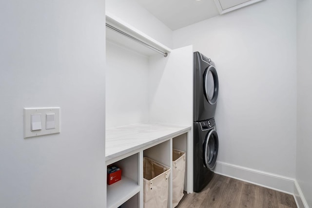 156 Beacon Point Dr, Santa Rosa Beach, FL 32459 - clothes washing area featuring stacked washer / drying machine, wood finished floors, and baseboards