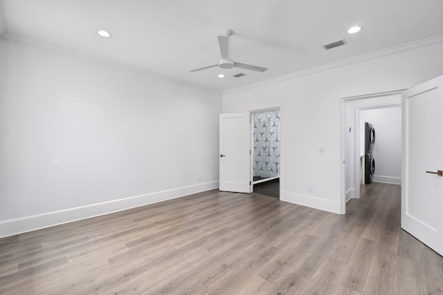 156 Beacon Point Dr, Santa Rosa Beach, FL 32459 - unfurnished bedroom with crown molding, stacked washer / dryer, recessed lighting, baseboards, and light wood-type flooring