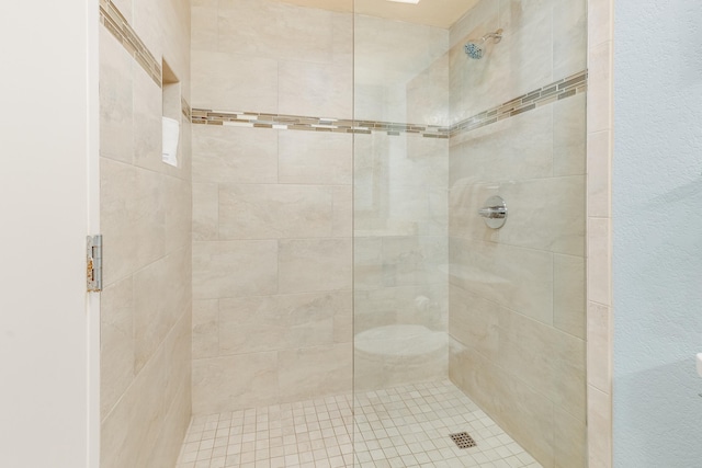 bathroom with tiled shower