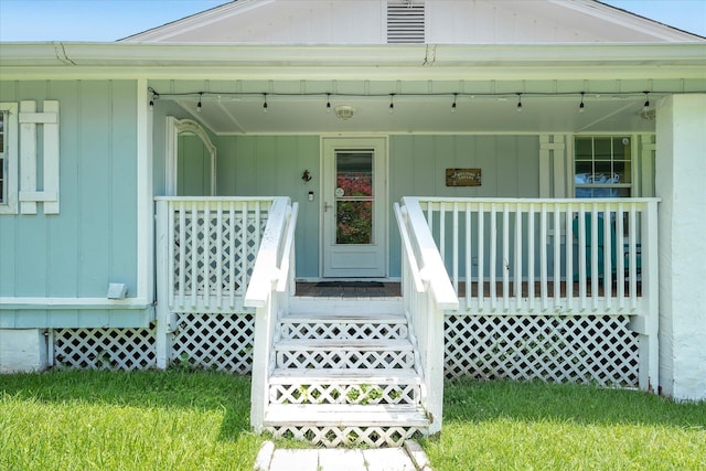 property entrance featuring a porch and a yard