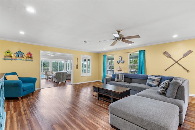 living room with ceiling fan, a healthy amount of sunlight, hardwood / wood-style floors, and ornamental molding