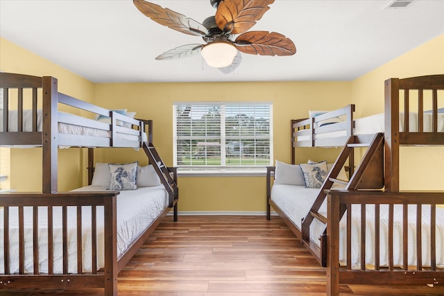 bedroom with ceiling fan and hardwood / wood-style floors