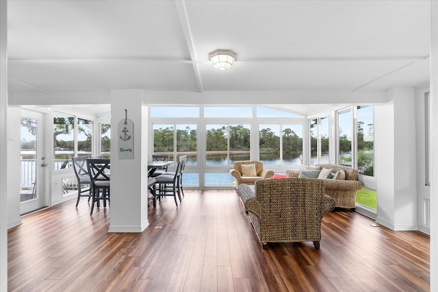 sunroom featuring a water view