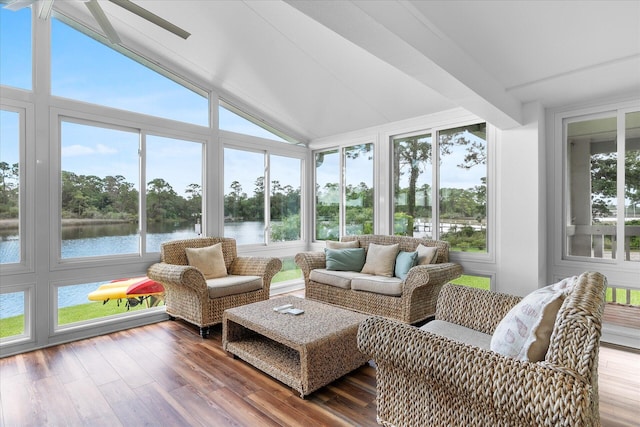 sunroom / solarium with ceiling fan, a water view, and lofted ceiling with beams