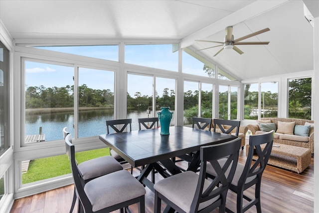 sunroom / solarium featuring ceiling fan, a water view, vaulted ceiling with beams, and plenty of natural light