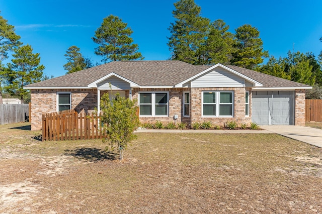 single story home with a front lawn and a garage