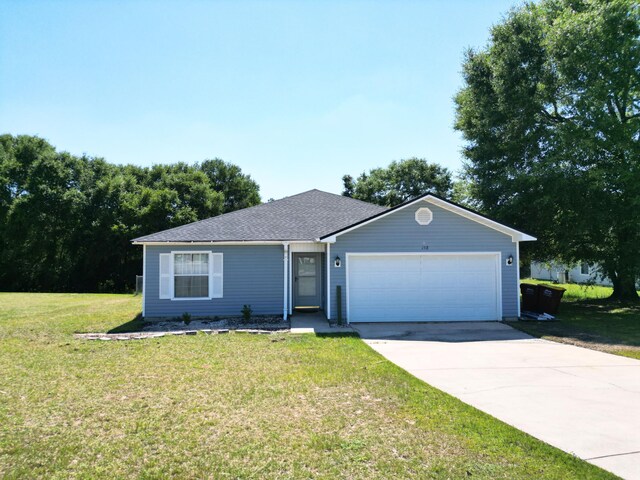 ranch-style house featuring a garage and a front yard