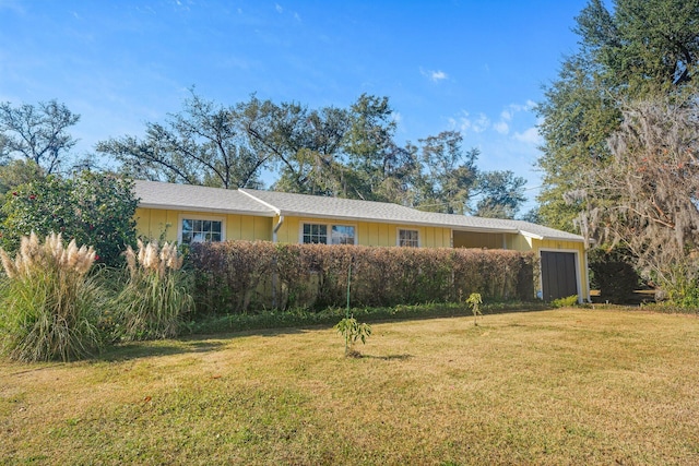 ranch-style house with a front yard and a garage