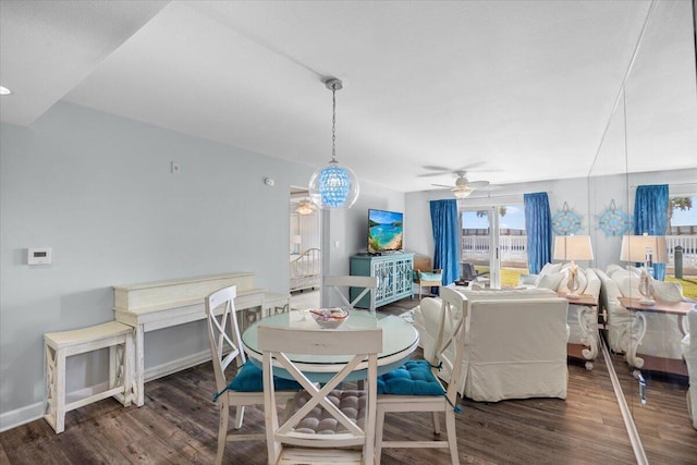 dining space with ceiling fan and dark hardwood / wood-style floors