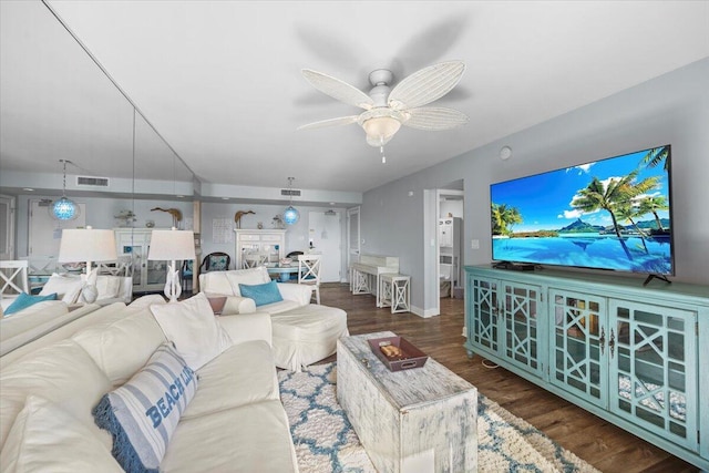 living room with dark hardwood / wood-style flooring and ceiling fan