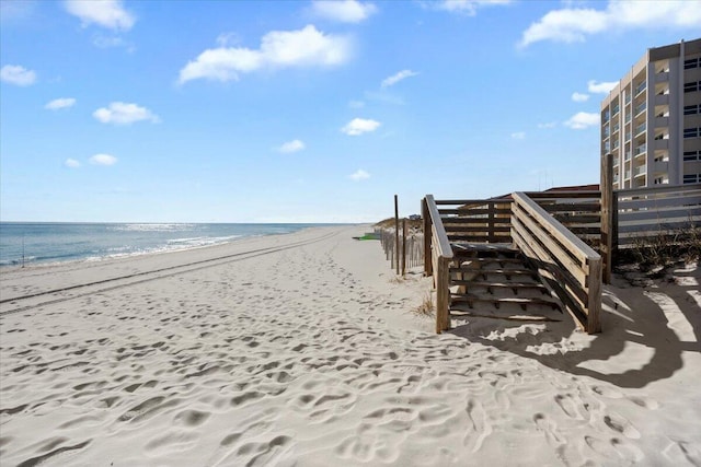 view of home's community featuring a beach view and a water view