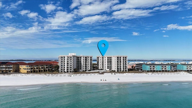 birds eye view of property with a water view and a view of the beach