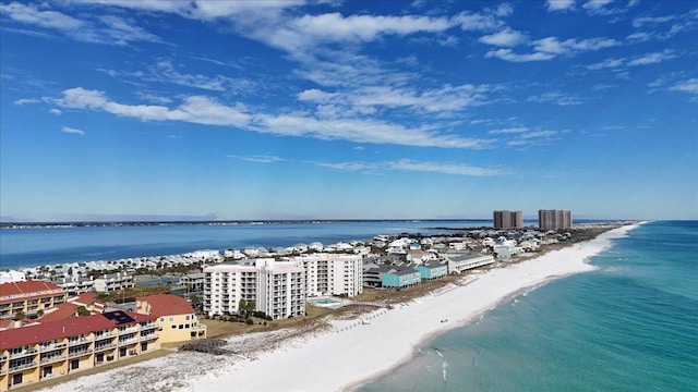 bird's eye view with a water view and a beach view