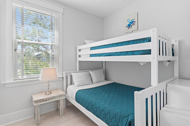 bedroom with wood finished floors and baseboards