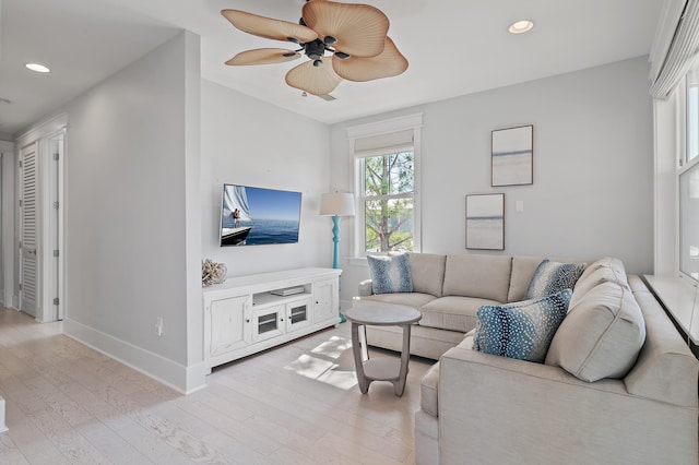 living area with baseboards, light wood-type flooring, a ceiling fan, and recessed lighting