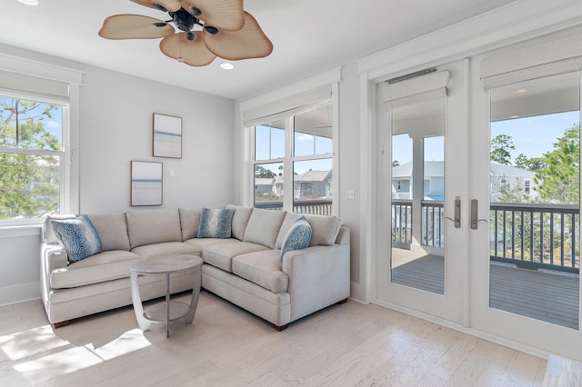 living area with ceiling fan, light wood finished floors, recessed lighting, and baseboards