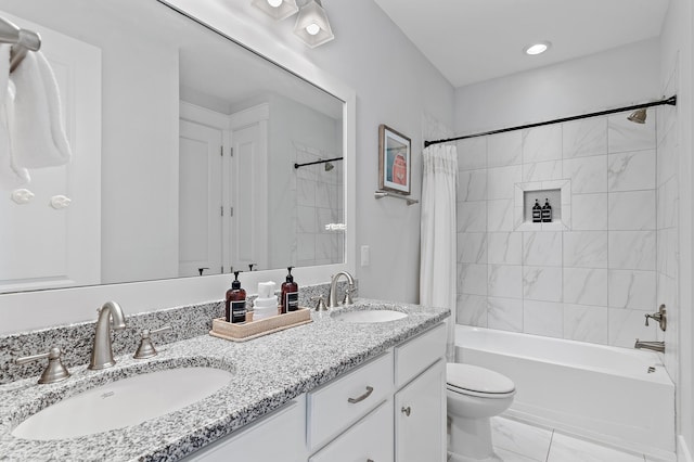 bathroom with shower / bath combination with curtain, double vanity, a sink, and toilet