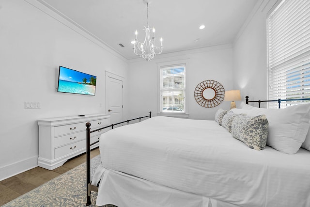 bedroom featuring a chandelier, hardwood / wood-style floors, and ornamental molding