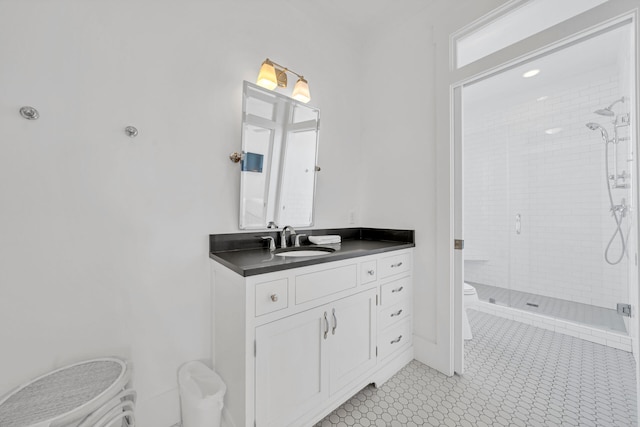 bathroom with toilet, vanity, and a shower with shower door