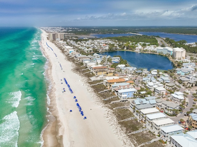 drone / aerial view with a beach view and a water view
