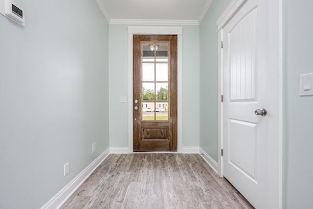 entryway featuring ornamental molding and light hardwood / wood-style flooring