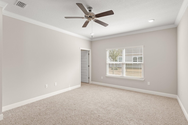 unfurnished room with a textured ceiling, carpet floors, ceiling fan, and crown molding