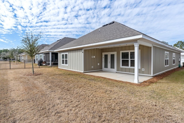 back of house featuring a lawn and a patio area