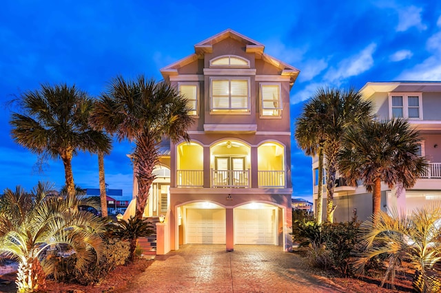 view of front of home featuring a balcony and a garage