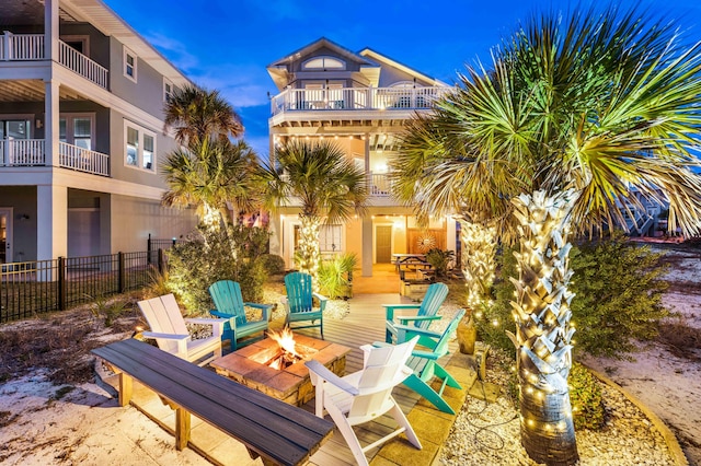 patio terrace at dusk featuring a fire pit