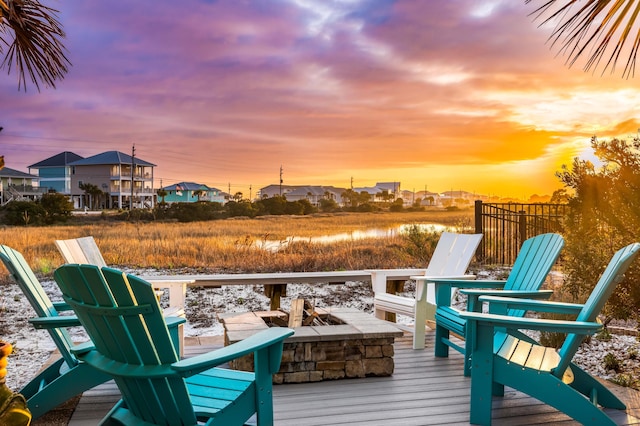 deck at dusk with a fire pit