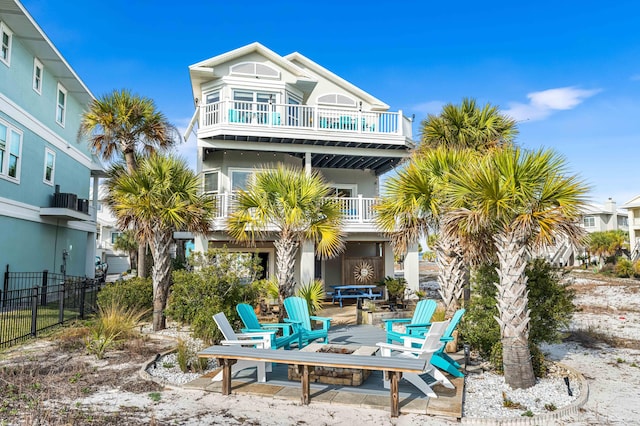 rear view of house featuring a balcony and a patio area