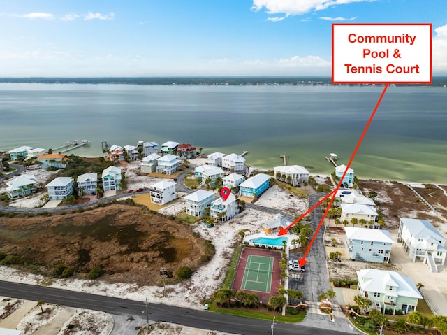 birds eye view of property with a water view