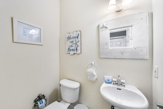 bathroom featuring sink and toilet