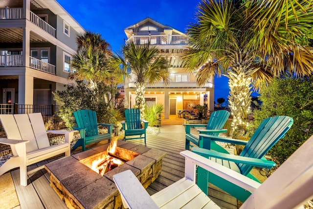 wooden deck featuring an outdoor fire pit