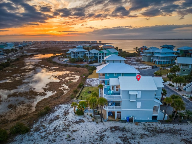 aerial view at dusk with a water view