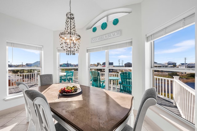 tiled dining area featuring a chandelier