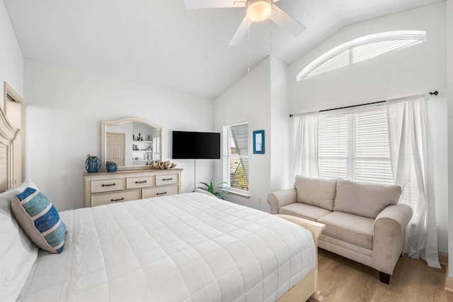 bedroom featuring lofted ceiling, ceiling fan, and light wood-type flooring