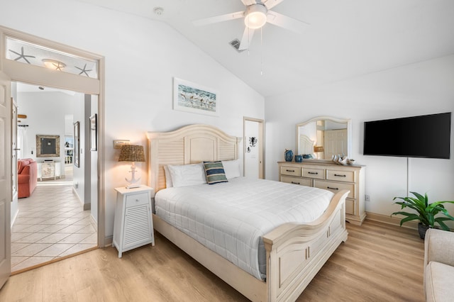 bedroom featuring vaulted ceiling, light wood-type flooring, and ceiling fan