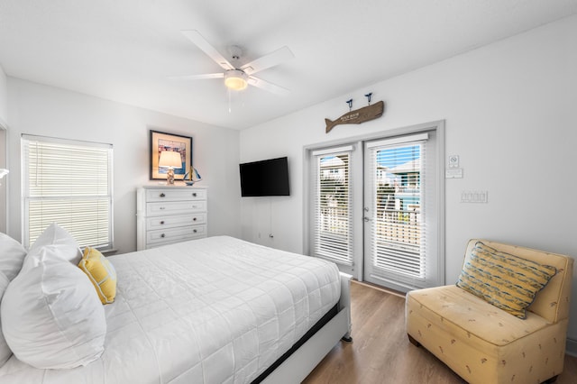 bedroom with ceiling fan, access to outside, and hardwood / wood-style floors