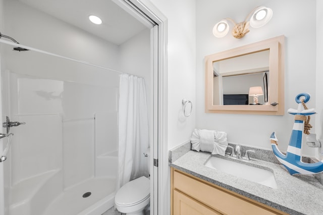 bathroom with toilet, a shower with shower curtain, and vanity