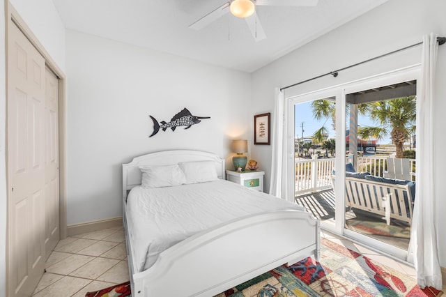 bedroom with ceiling fan, light tile patterned floors, a closet, and access to exterior