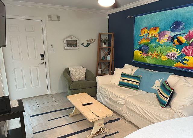 tiled living room featuring crown molding