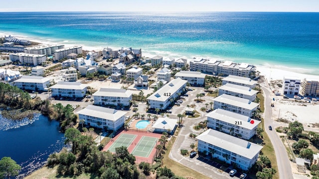 birds eye view of property with a beach view and a water view