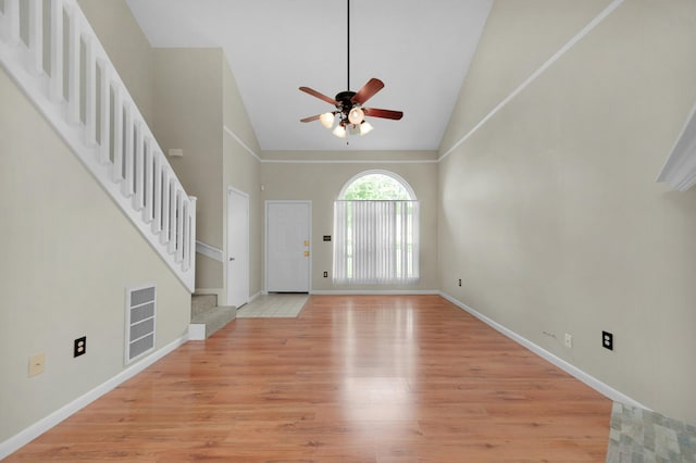 entrance foyer with high vaulted ceiling, ceiling fan, and light wood-type flooring