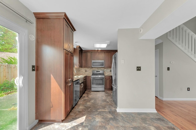 kitchen with sink, tasteful backsplash, and appliances with stainless steel finishes